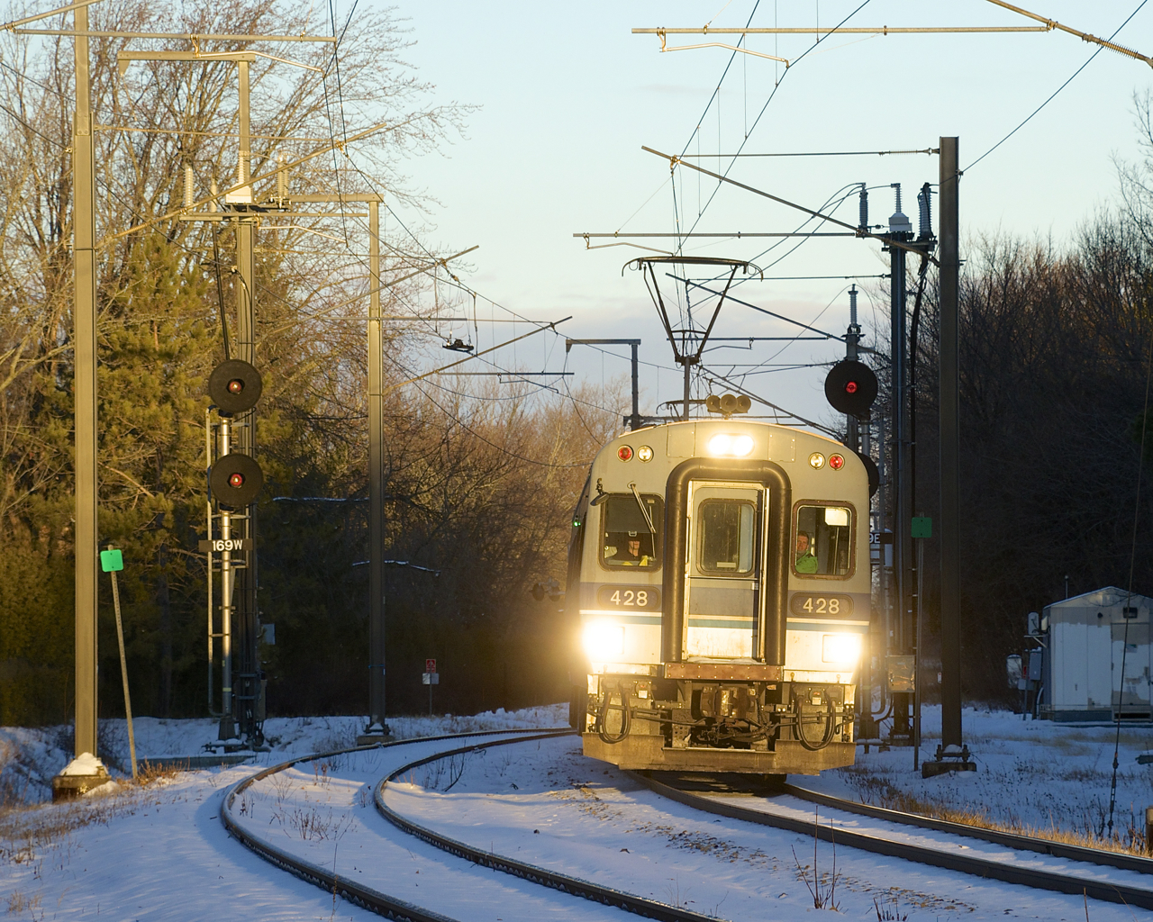 The sun has risen high enough to illuminate EXO 932 as it passes the siding at MP 16.9 of the Deux-Montagnes Sub during the final morning rush hour for this line. Already truncated so that trains terminate at Bois-Franc Station since this past spring (instead of going all the way to downtown Montreal via the Mount Royal tunnel), the rest of the line will be shut down and all the tracks and infrastructure torn up after today. It will be replaced by the controversial REM light rail project, which is only set to be in service here during Q4 2024.