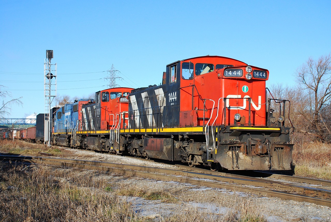 A nice sunny day on Christmas break had many railpictures.ca contributors out to photograph the CN and CP locals in beautiful north-end Hamilton today.  The CN 07:00 job had the triple-set with GMD1us 1444 and 1408, and GTW GP38-2 5849, so that's what I was after this morning.  The "700" is seen about to hit the CP diamond, just west of Gage Avenue North.  The CP local was working Adams Yard already, and radio communication between the two railroads provided us with their game plan for the day.  Too bad CN had foreman working on the N&NW spur.  The 07:00 job was only able to work Parkland Terminal before getting held up from working the CP interchange and switching Stelco.  What seemed like a simple work plan turned in to a long day for the crew.
