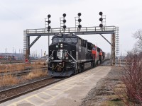 CN M394 climbs the grade out of the St. Clair River Tunnel passing under the Westbound signals at CN Hobson with none other than the IC heritage unit leading