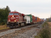 CP #142 is underway after making a setout and pickup at the east yard in Smiths Falls. The train has over 13,000 tons with only 8842 as a DPU to help 8886. While they were permitted to run at 60 mph, the crew told the RTC "not to expect any miracles". In response, the RTC arranged for #143 to take the siding in Winchester so #142 could hold the main.

Clearly, Red Green has hired on with CP, and was assigned to fix the numberboard for 8886.