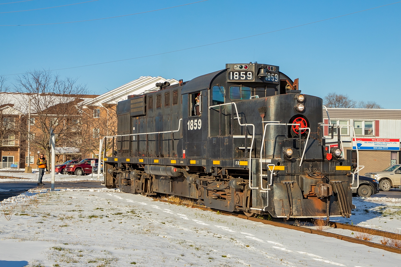 After spotting one load at the Port Colborne Grain Terminal, TRRY 1859 heads back up through town up the Government Spur towards the junction with the Harbour Spur.