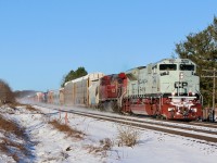 Fresh powder and bright sunlight make for a nice combination as CP train 234 storms eastward near the GO station in Meadowvale. Lead unit SD70ACU #7022 carries a special military paint scheme as it kicks up the fresh snow. The old base for the Meadowvale water tower can be seen in the background and is now rebuilt into a cell tower.