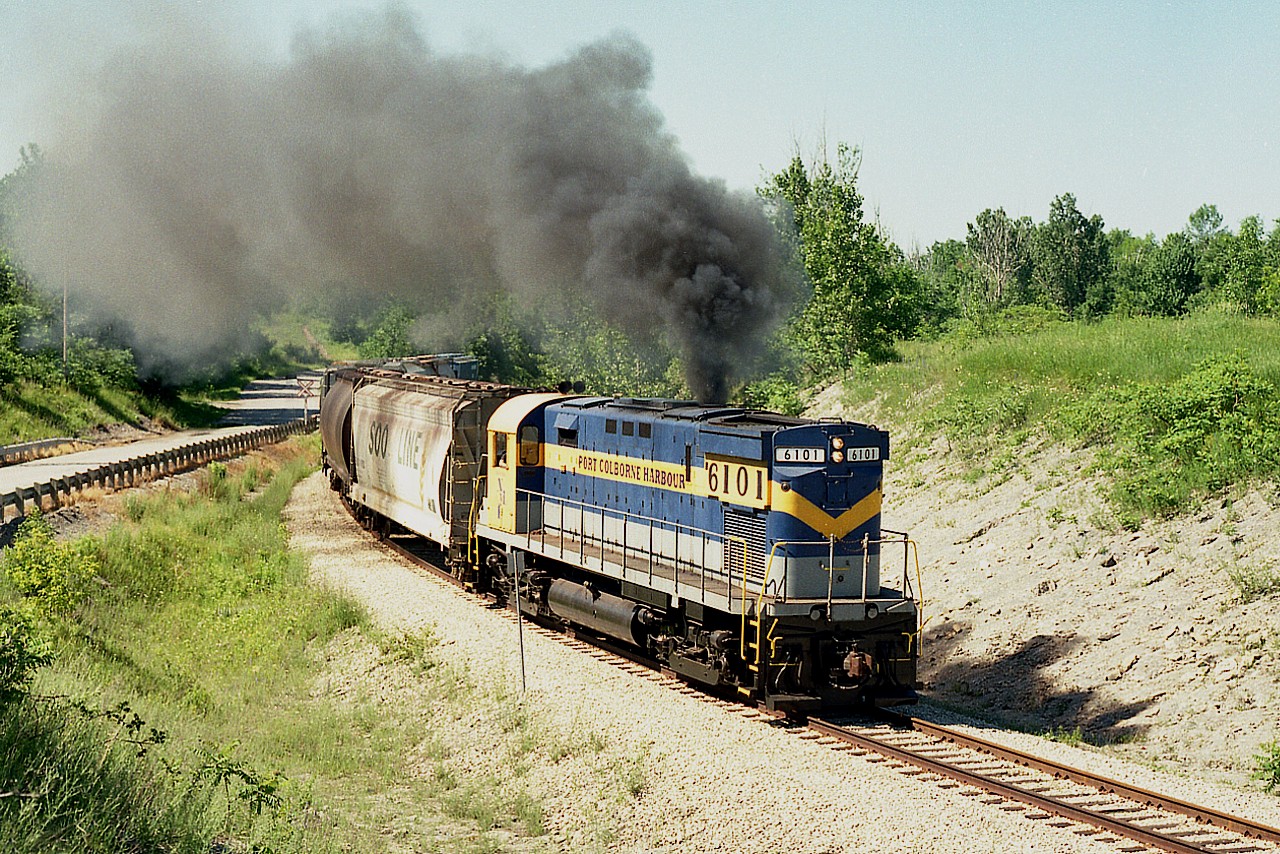 (Port Colborne Harbour Railway became Trillium a few years after its conception)
    Although the official Opening Festivities did not take place until July 2, 1997; the PCHR was out and about by the latter part of June.
    In this image, former NY&LE 6101 did its best to show us what it was, an ALCO, as the C-425 throttled up pulling away from the Robin Hood Mill area on its way to Casco and the WH yard, just a few miles down the line.

    The PCHR started off as a 7.7 mile line connecting Welland and Port Colborne. It was operated by the Caledonia and Hamilton Southern Railway, Ltd. (I'm wondering what ever became of that outfit)
    The much traveled NY&LE #6101 came to the PCHR as their sole locomotive, as the "C&HSR" was affiliated with the New York & Lake Erie. In 1991 the 6101 was returned to the NY&LE and then ended up on the Delaware-Lackawanna in Scranton, PA in 2007; where it still resides today. Doubt it has quit smoking.