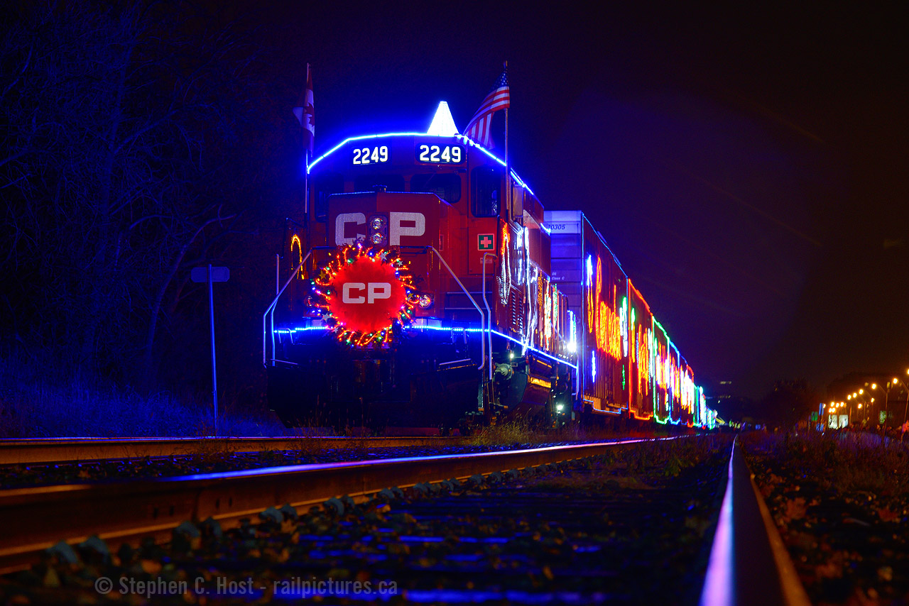 With the 2020 Holiday Train becoming virtualtomorrow (December 12) due to obvious reasons, I thought I'd pull an old image of mine out from the 2014 train when the ECO's made their first of many treks across the country hauling the Holiday Train.  What was great is this was the first year, to my knowledge, they had amazing crowd control so you could get a clear shot of the train - I took this photo with permission of the CPR Police guarding the crossing :)
Be sure to offer your usual support to our friends at the Canadian Pacific for this years event and tell your friends and family, there are sure to be some amazing surprises in the virtual event. There will be an appearance by CPR 2816 under steam in 2020! Cheers and wishing everyone a Merry Christmas (a little early!).