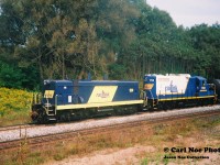 A Southern Ontario Railway (SOR) train is heading west on the CN Dundas Subdivision up the grade at Copetown with RLK 1200 and RLK 1752 with cars for either Brantford or Paris from Hamilton. At the time, the Inksetter Road bridge was undergoing a complete overhaul and was completely removed over the CN mainline. 

Previous image posted seen here:

http://www.railpictures.ca/?attachment_id=40576
