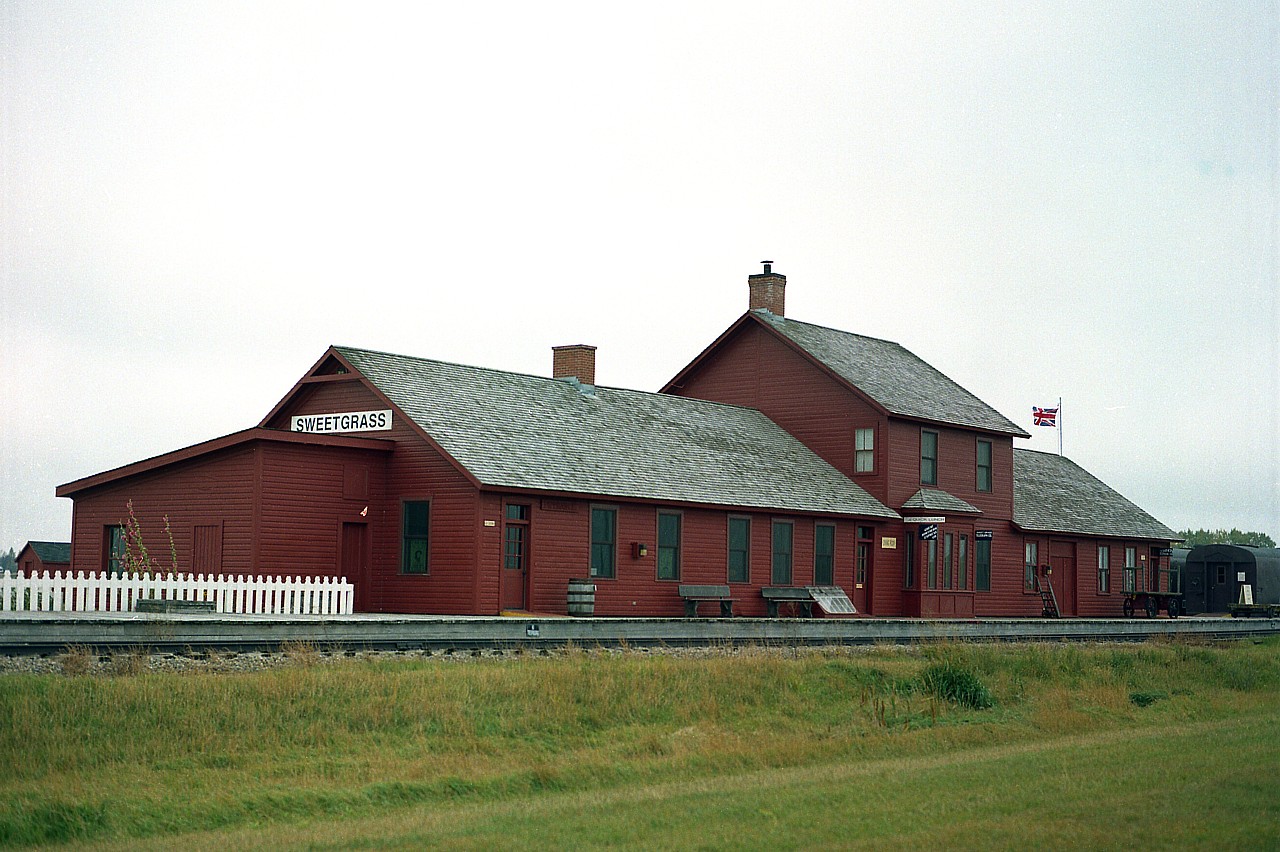 The Galt Historical Railway Park. Definitely not the "Galt" we know in Ontario, as in "Galt Sub" but rather a tribute to the Galts, Sir Alexander and his son Elliot T. Galt. The Galts were responsible for really getting Alberta coal mining into the boom years with their incorporating of the North-West Coal and Navigation Company in 1882. They had a hand in almost everything coal. They incorporated, in Montana, the Great Falls and Canada Railroad, to build a line to the Canadian border at Sweetgrass, MT. A subsidiary company, the Alberta Railway and Coal Company, built from Lethbridge down to the border at Coutts, which, like Sweetgrass, hugged the boundary. This railroad project was completed by 1890.
In 2000, the massive Sweetgrass station was moved to the newly formed Galt Historical Railway Park, about a mile north of the town of Stirling, Alberta. The structure was built in 1890 and actually straddled the Montana-Alberta border, making it at one time a true 'International' station.  Massive indeed.
