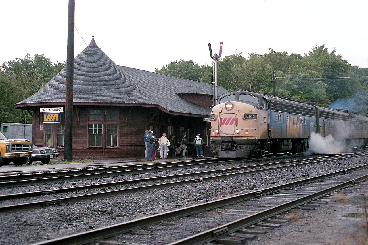 It is a dull overcast Sunday afternoon as the southbound Toronto edition of the Canadian comes 'steaming' to a station stop at the CP station in Parry Sound. There are a few passengers but otherwise the same old characters wander over to meet the train and shoot the breeze. This scene is 35 years old already; the station is now a commercial enterprise and all the characters have moved on. Having said that, this character has moved on as well. Parry for trains is still busy, but the human interacting side of it is gone, longer nondescript trains with a single unit, or two, up front, a DPU and they all seem to look the same.