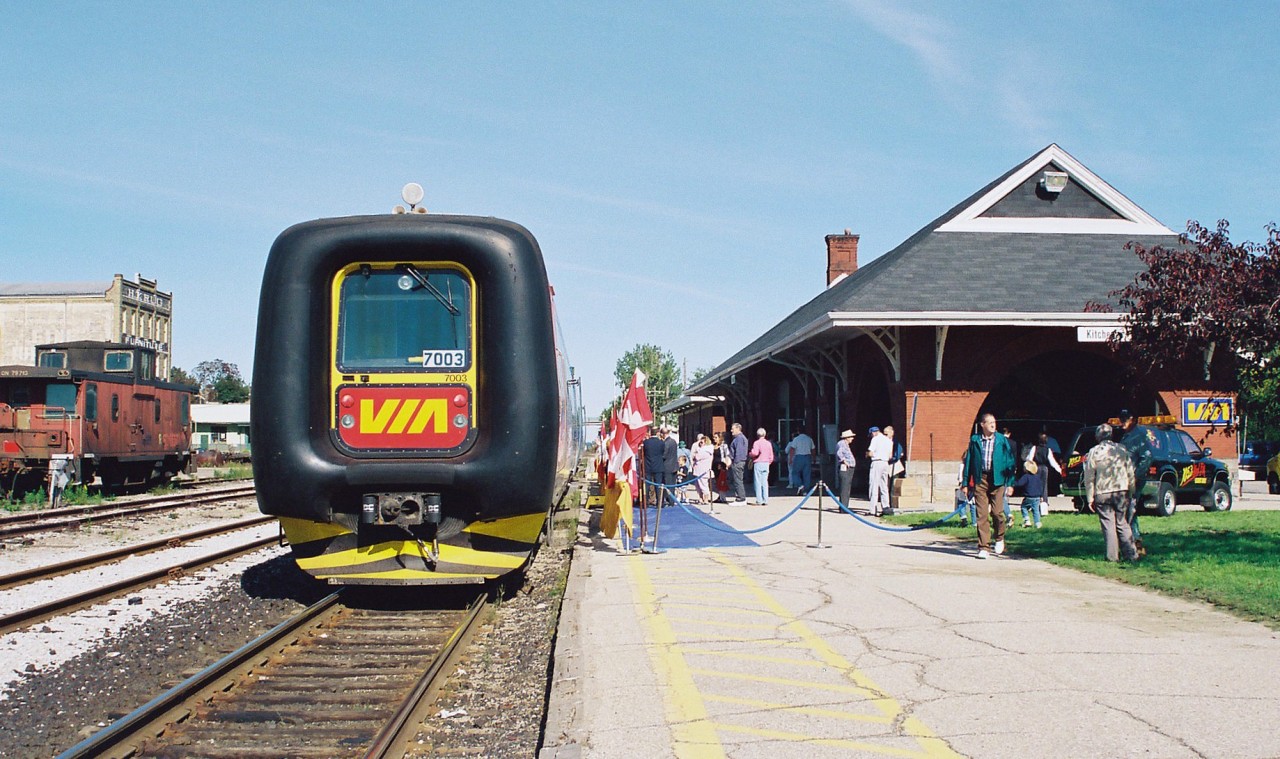 In September 1996, VIA Rail had launched the testing of two IC3 Flexliner demonstrator sets on some of their routes throughout Ontario. These new units were designed and built by ADtranz, which was a new company spin-off created from ABB and Daimler-Benz. These two trainsets entered revenue service on September 29, as it was concurrent with the release of the new VIA Rail system timetable that touted the trains as a “commuter service.” However, just as quickly as they began service they were removed on September 30 as they were found to not be reliably activating track circuitry due to their light weight. Eventually, after 7 weeks of further testing and modifications they were deemed fit to return to service where they operated on assignments from Toronto to Ottawa, Stratford, London and Niagara Falls in various schedule rotations. One set would operate until March 1997 and the other stopped running in early May. In the end, the tests were reportedly not successful and VIA Rail felt the technology would not “fit their needs.”
Here, VIA Rail officials had rolled-out the blue carpets for an official unveiling at the Kitchener station during a weekday afternoon. This trainset was on display for several hours before heading west to Stratford later in the evening on the Guelph Subdivision.