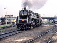 May 2021 be a year of joyful surprises as June 19, 1980 in Toronto was.
Paul Woodring and I were riding a GO train from Burlington into Toronto when I looked over at CN's Spadina engine terminal. I saw smoke! We rushed over to Spadina, signed our releases, and entered the engine facility. CN 6060 was running back and forth on one of the tracks. When it stopped, I asked if we could have a cab ride. Since we had signed photography releases, we were allowed to have our cab ride. We went up and down that piece of track two or three times. Then the ride was over. How blessed we were.
As to this photo, it's not perfectly centered. I know that, but the last thing I was thinking about was perfect photographic composition. I just wanted some slides of CN 6060 all steamed up!