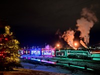 Decorated with festive Christmas lights, 2816 shines within CP's brightly-lit Ogden campus in Calgary during filming of the "Holiday Train at Home".  The tower's of Calgary's downtown core gleam in the background as the 90 year-old Hudson simmers quietly waiting for her turn in front of the camera.