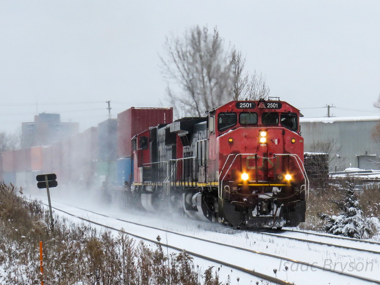 A late Christmas present from CN. I'm wrapping up a mini-chase with CN 107 and GO 625 north of Toronto when I get the word that CN Q101 has CN 2501 (Canadian Safety Cab Dash 9) leading coming out of Brampton. Turn on the scanner and low and behold, CN 101 is asking about CN 105s location on the York and it is passing Mac yard. A couple trains later (Z114 in Gormley and Q105 minutes earlier), CN 101 makes its way north with a gorgeous sounding mechanical bell on the front end of CN 2501. A little bonus was the class lights activated on the C44-9WL. Everyone is talking about the Dash 8s being on borrowed time but I don't think these won't be around for too much longer either.