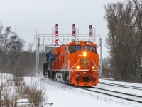 CN Z114 (priority intermodal Winnipeg-Toronto) flies south through CN Quaker with Elgin Joliet & Eastern CN 3023 and GECX "Blue Demo" 2037. CN 3023 is one of 6 units that are a part of CNs program to commemorate 5 companies (CN, EJE, WC, BCOL, IC) folding into 1 company CN, and also GTW. GECX 2037 is one of 12 Tier 4 demonstrator units, and 1 of 4 that have not been repainted into CN colours. Overall, a very interesting train to shoot!

Note* if looking for this shot, please be aware that the road on both sides of the crossing is atrocious with uneven gravel and potholes creating massive bumps in the road. 