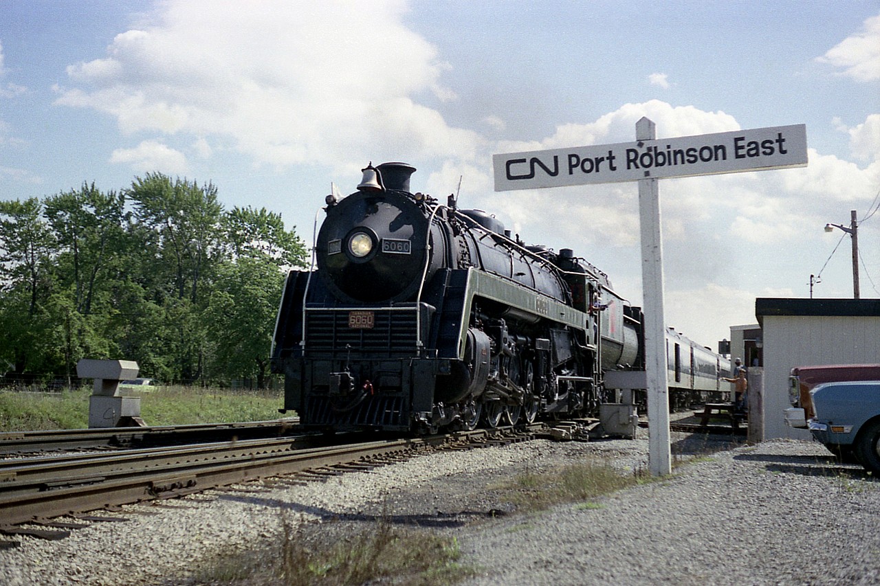 On a Wednesday side trip from Niagara Falls to Yager and back, CN 6060 passing the office at Port Robinson gets a friendly wave from the local lads.  This tourist train run from Toronto to NF and back with side trips to Yager were tremendously popular in the late '70s.