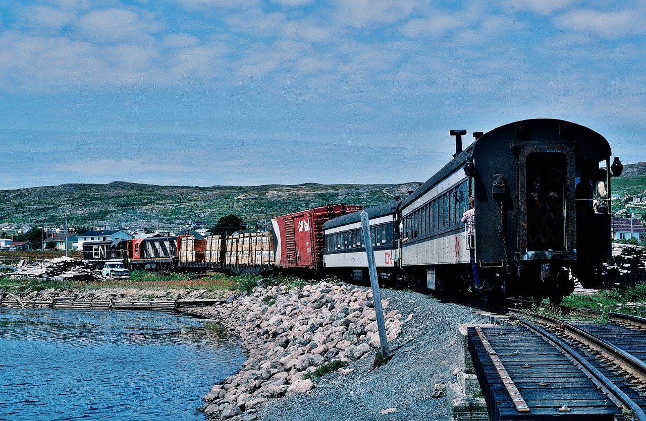 ....      The Rock   ......


				....     Very   Unique    ..... 


 ... on a warm sunny breezy beautiful Newfoundland summer day … the mixed trains were well patronized....


 Upon arrival at Carbonear, Terra Transport train #231( Tuesday, Thursday, Saturday ) spotted a CN box car and lifted a CP Rail box car plus two lumber loads, 


After a crew lunch break, TT train #232,  Carbonear to St.John's  ( Tuesday, Thursday, Saturday), is shown departing Carbonear 14:00 (scheduled 13:20)     


 Today's GMD 1956 built power: G-8's  805 – 800, the former now resides at the CRM, Saint-Constant P.Q.


  at Carbonear, Newfoundland  -  The  Rock  -    August 7, 1982 Kodachrome by S.Danko.


 More Carbonear:


   Terra Transport #232   
 

 sdfourty