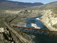 Eastbound train 416, intermittent traffic Port Mann to Edmonton, crosses the Thompson river east of Ashcroft. CP main is on the left. CN predecessor Canadian Northern made several crossings of the river as earlier constructed CP built on the most stable side .