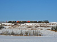 Big power on the former Northern Alberta Railway used to mean SD38-2's, however in 2021 this could mean any assortment of power on the CN roster.  Here we see 419 climbing out of the Sturgeon River Valley on its daily run from Edmonton to McLennan. BCOL 4648, IC 2461, CN 5613 and IC 3140 are in charge of this 118 car, 8170ft train.  Of note, operating 25 minutes behind BCOL 4648 north, was G 84951 29 with BCOL 4646 and CN 5620.  