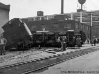 Mid day on May 27, 1953 finds CNR E-10-a 2-6-0 Mogul 88, the lead locomotive on a double headed freight up the mountain, tossed on her side at the intersection of Ferguson Avenue and Rebecca Streets in Hamilton.  This derailment was caused by the lead wheels of 88's tender picking the switch of the Rebecca Street spur, jackknifing the engine causing it to flip.  The three crew members onboard; Engineer Charles Penfold (jumped clear), Fireman Richard Day, and head end Brakeman Murray Calder, all escaped with minor injuries.  The tender has been partially righted in this image, and is supported by timbers after having made contact with the Alexanian Oriental Rug Cleaning Company building.  The trailing 3506 <a href=https://scontent-yyz1-1.xx.fbcdn.net/v/t31.0-8/10273403_787377977947164_3356333114880696233_o.jpg?_nc_cat=109&cb=846ca55b-ee17756f&ccb=2&_nc_sid=cdbe9c&_nc_ohc=sUAd0WwO6bsAX8Y0mRW&_nc_ht=scontent-yyz1-1.xx&oh=0dcee9a4794054948ccd19d5de4d704f&oe=601D781F>followed 88 down the spur</a> stopping short of the yard engine working nearby industries.  After 3506 and the rest of the train returned to Hamilton Yard, a steam wrecking crane was brought in to clear the mess.<br><br>CNR 88, built as Grand Trunk 1008 by CLC in 1910, renumbered GTR 910 in 1919, CNR 910 in 1923, and CNR 88 in 1951.  After this wreck, which cracked the crown sheet atop the firebox, 88 would be sent to Stratford for repairs.  Retired in 1957, she would be placed on display <a href=http://www.railpictures.ca/?attachment_id=24212>as GTR 1008 just east of Morrisburg, Ontario</a> along Highway 2 near the Upper Canada Pioneer Village.  Along with it sits the historic Aultsville train station and two GTR coaches.  CNR S-1-g Mikado 3506, built by CLC as GTR 486 in 1917, would be scrapped just over 4 years later in July, 1957.