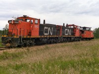 I heard this train pass through Redwater and it is into the car and head for Kerensky. When the 1082 arrives at Kerensky, they hold up at the south connecting track switch, getting further orders to proceed I assumed. While waiting, I notice the work train coming from the north and taking the siding at Egremont. It had been working in the area the last few days. This was making sense now, the 1082 was waiting for the work extra. I zip over to photo the work extra and end up talking with the brakeman. He tells me the 1082 is here to take empty flats stored on the abandoned portion of the Lac La Biche Sub. The army needs 40 to move equipment. A huge string of flats had already taken out a few weeks earlier, which would mean 1000's to reach the remaining cars on the light 60lb. rail. Well, it is off to catch up with the 1082, a rare opportunity has presented itself, to photo ex-NAR 1000's back on home rails. Here they are about 2km west of the north connecting track switch. The flanger clearance sign is for range road 221, which is just behind me. Not much further to go to couple on. In short time they had their cars and were headed back for Edmonton.