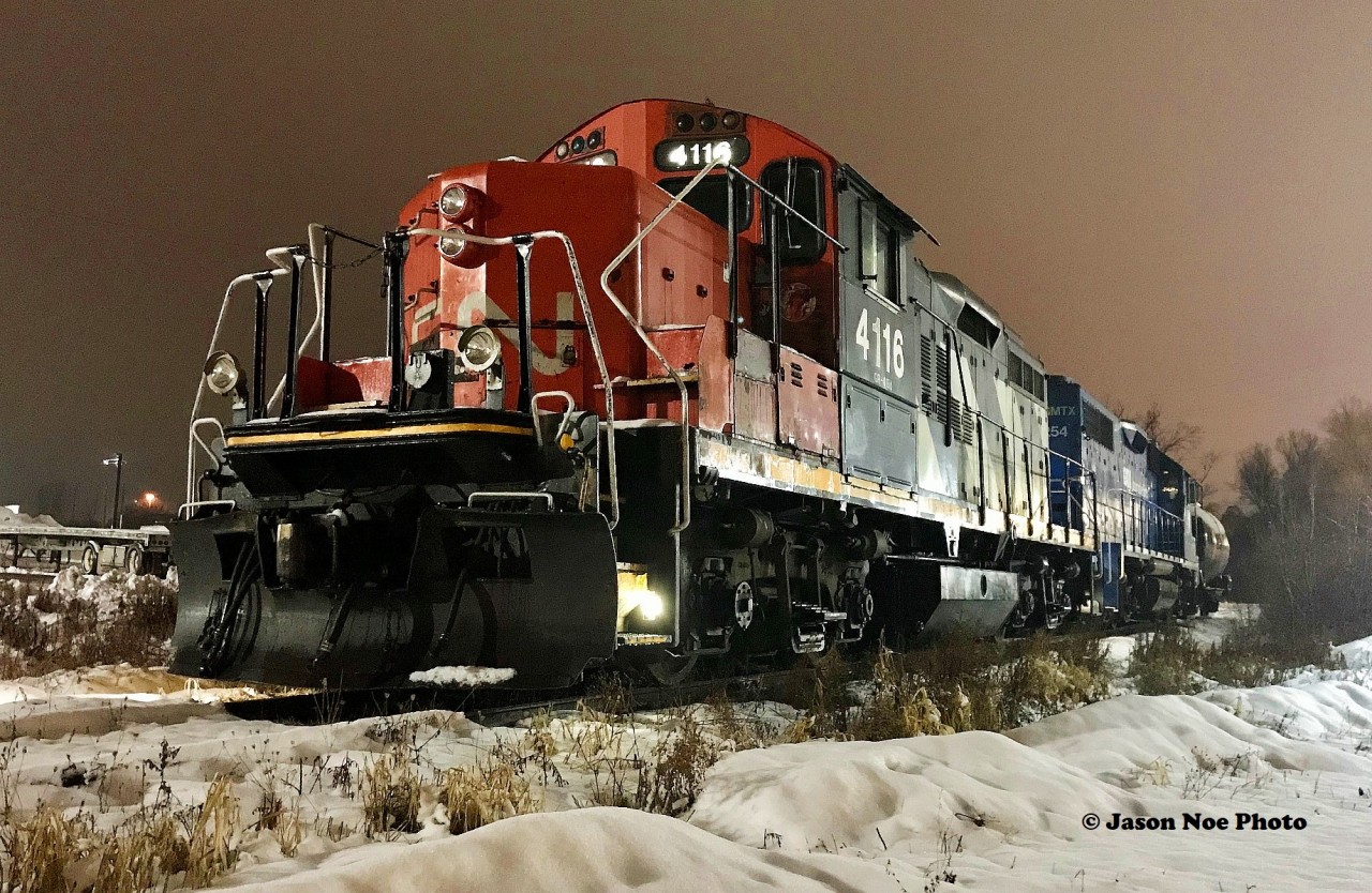 CN 4116 and GMTX 2254 idle away on Groundhog Day in Cambridge, Ontario on the Fergus Spur. This set of power is used on CN L542, which services customers around the Cambridge and Guelph area. February 2, 2020.