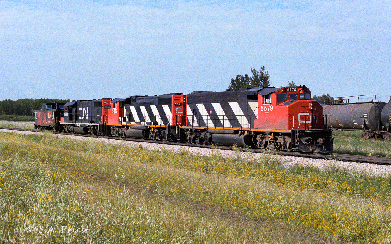 A cab hop headed due north here, destination will be Waterways to pickup 50 loads of sulphur and return to Edmonton. The 5533 in the black noodle paint was a rare visitor, this being my only time taking photos of it. To connect to my last post of the 1082 in 1985 on the abandoned Lac La Biche Sub. Behind the 5579, you can see ammonia tanks now stored on the old abandoned track. In 1985 they stored cars here twice, springtime with flats (the 1082) and covered hoppers in the fall, which returned from storage in October back to Edmonton (an older previous post of mine with the 1069). The ammonia tanks will return in the fall of 86 and I believe they never stored cars here again. I will not be much longer until the old 60lb rail was removed. My photo of the 1082 is approx. 2km west of this spot, down the track with the tanks on it. I added GPS as you can still see where the old tracks ran in the aerial photos. Time of this photo, 8:30 on the north end of the connecting track, shot with Kodak 100ASA film.