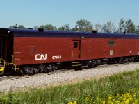 This is the promised baggage car from the auxiliary train I posted a short while back. Checking my 1989 CTG, it is reported to have been built in 1950 by NSC. Here, 38 years later, it is looking immaculate. I don't know when it was converted to Aux. Gen/Comm car 57958, it was obviously enjoying life in its new role, as it is very well cared for (nice yellow trim). Checking my other posted photo and the roof line in this picture, that seems to be the diesel with generator at this end (flapper on exhaust). The other various vents and chimneys??? All the equipment, minus a coach, is on the way back home to Calder yard. Photo taken south of Gibbons at 9:15.