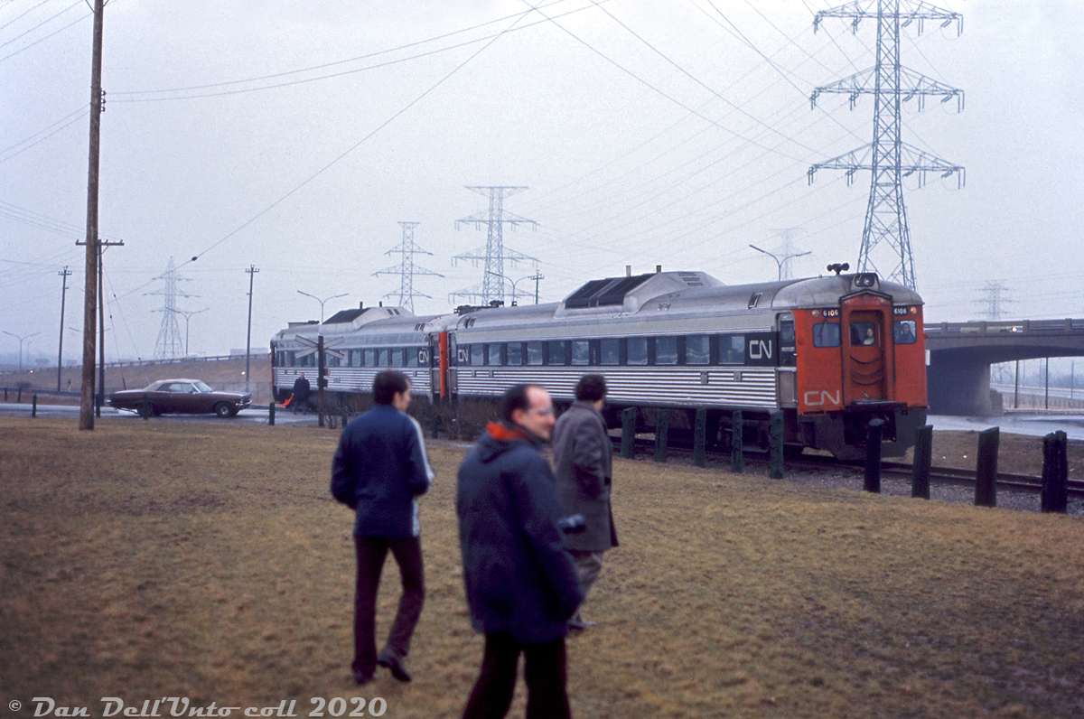 It looks like someone didn't have their railfan filter on their lens (anyone look familiar here?). The Upper Canada Railway Society held a fantrip on March 9th 1974 using CN "Railiner" RDC cars 6106 and 6111 that toured the Toronto Bypass (York & Halton Subs) and Beach Sub on a trip between Pickering and Stoney Creek, which included a special run down the Milton Townline Spur across the CN-CP diamond to Milton Station, and a trip down the Beach Sub (with a photo stop on the lift bridge at Hargrove). Here, a photo stop ensues near Stoney Creek as the two RDC's proceed south with a crewmember flagging the Van Wagners Beach Road crossing near Beach Blvd. The QEW is visible on the right, where Beach Blvd. ducks under it.The gloomy weather foreshadowed the fate awaiting the CN Beach Sub (aka the "Beach Branch") in the near future. Most CN mainline traffic used the more popular Oakville & Grimsby Sub mainlines through Hamilton, and the old Beach Sub (originally part of the Hamilton & North-Western Railway) between Stoney Creek and Burlington was soon to be severed into two spurs by QEW freeway construction that took place in 1974-1975 (which included removal of the famed QEW traffic circle). The main spur ran south from Burlington to service a customer near Stoney Creek for a few more years, but was later abandoned in 1981 and removed, leaving only short stubs on either end.Gord Taylor photo, Dan Dell'Unto collection slide.