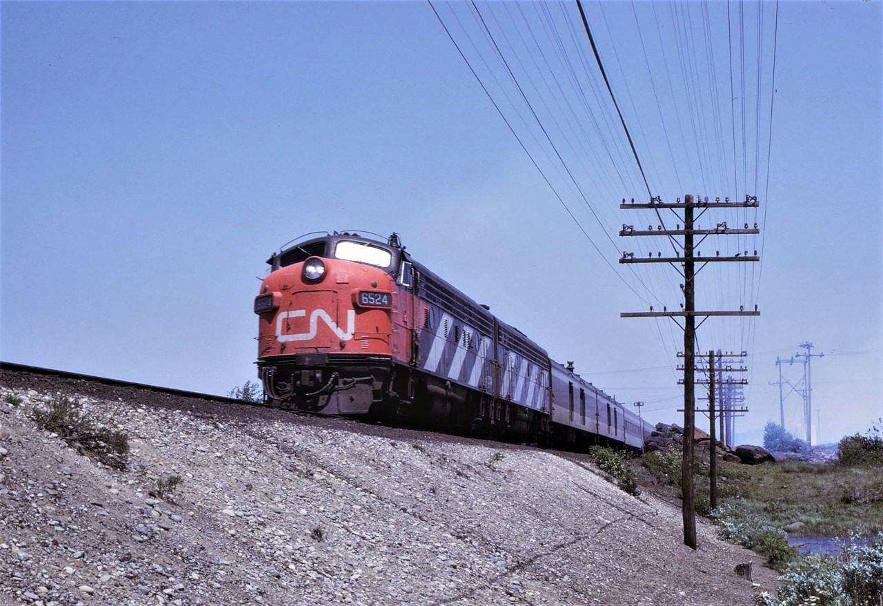 The Toronto section of the Super Continental, train #52, heads south out of Capreol, Ontario with a clean GMD A-B pair complete with stripes matching.  Units are 6524 and 6624.