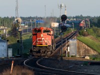 The crew of the 8800 are turning their units on the wye at Bretville Jct. After stopping, getting lined up and a light, they will proceed to Clover Bar yard. Waiting in the distance, on the other side of the river at Bailey, is a lumber train. After the lumber train departs, an IM from the Camrose Sub. arrives and continues to Walker yard. Within minutes, another east bound of empty hoppers on the Wainwright Sub. goes by. It was early on a Sunday and already it was shaping up to be a busy morning.