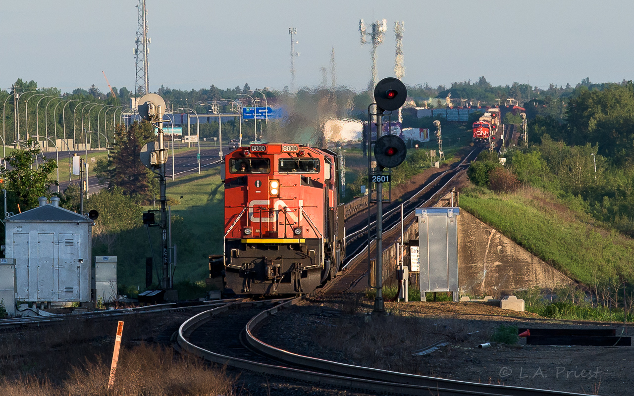 The crew of the 8800 are turning their units on the wye at Bretville Jct. After stopping, getting lined up and a light, they will proceed to Clover Bar yard. Waiting in the distance, on the other side of the river at Bailey, is a lumber train. After the lumber train departs, an IM from the Camrose Sub. arrives and continues to Walker yard. Within minutes, another east bound of empty hoppers on the Wainwright Sub. goes by. It was early on a Sunday and already it was shaping up to be a busy morning.