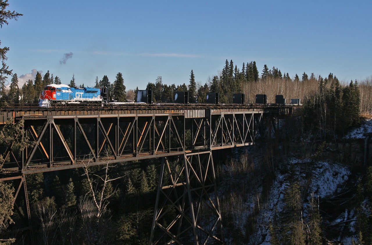 CN M 34791 10 soars high above the Pembina River in Entwhistle, Alberta.  CN 8952 is sporting an attractive rendition of the Grand Trunk Western scheme, mixed in with some snow after battling a prairie storm the day before.