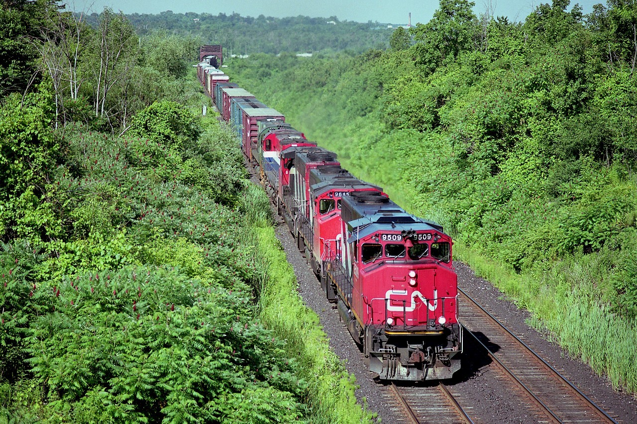 Beautiful summer Saturday morning in July.........CN 9509, 9645 and 9603 have just crossed the Welland Canal heading to the Falls and eventually Port Robinson with a couple of BCOL MLW M-630s in tow. At the time British Columbia Rail was ridding themselves of many MLWs in the fleet, and a number of them, as with #722 and 712 on this train were sold to GE. The units gathered in Frontier Yard, in Buffalo, as a visit there two days later netted pix of BCOL 703, 704 and 705 as well as the two featured here.  Photo taken from the Beechwood Rd bridge, south of the Glendale Av exit off the QEW. Mamiya 645 1000s, using Fujicolor Reala 100 ISO 120 roll film. The colours really "popped" with this stuff.
