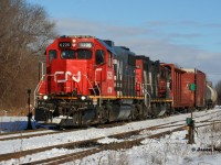 CN L540 returns westbound through Guelph from Acton on the Guelph Subdivision with GTW 6226 and 4028. The crew will lift three cars in Guelph before departing westbound towards Kitchener. December 29, 2020.