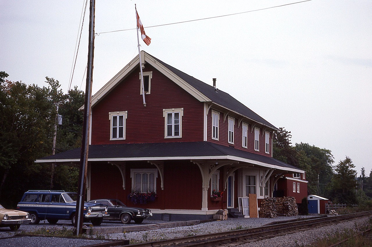 What a beautiful building. This former station is one of the oldest in Canada, with a construction date of Jan 1, 1858, and finished later that year for the European & North America Railway. This line ran from Saint John to Shediac, NB., back when the community was referred to as Kennebecasis. Cost of construction of this 3,000 sq ft structure back then was $2,500. 
The standard two story building as a passenger station was closed in 1975, despite the 'Atlantic' running thru until 1994. A rather cute VIA waiting room was built off to the left of where I am standing for those passengers that still used the service.
Recently a local photographer, Martin Flewwelling had his studio and gallery there on the main floor and the lower area was used for town meetings and such. It went up for sale for $325,000 in 2019. A classic, and since it was thoroughly renovated top to bottom and contained many artifacts, was probably cheap at twice the price.:o) With a road behind and active CN track in front, the only drawback would be lack of private property.
The structure as a National Historic Site of Canada.