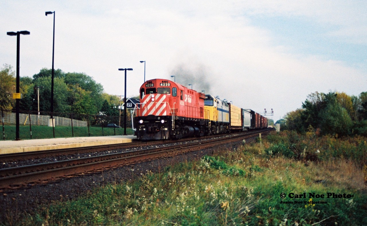CP train 923 with 4239 and VIA Rail 6455 is heading westbound at Streetsville, Ontario on the Galt Subdivision. During 1994-1995 CP had leased several VIA Rail units to assist them through their severe motive power shortage until the new GE's that were on order started arriving. 

Also of note; according to Branchline Magazine, this train also lifted new Caltrans F59PHM-I's 2003 and 2002 from London that day. Both of these had recently been built at the GMDD facility and were enroute to California.