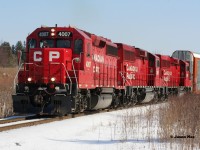 CP T72 with 4007, 2281 and 2242 is approaching Fountain Street and Hagey yard in Cambridge on the Waterloo Subdivision as it completes its trek from Wolverton with 18 cars for Toyota. CP GP40-3 4007 started out life as Milwaukee Road 2066 before becoming SOO Line 2066. February 22, 2020.