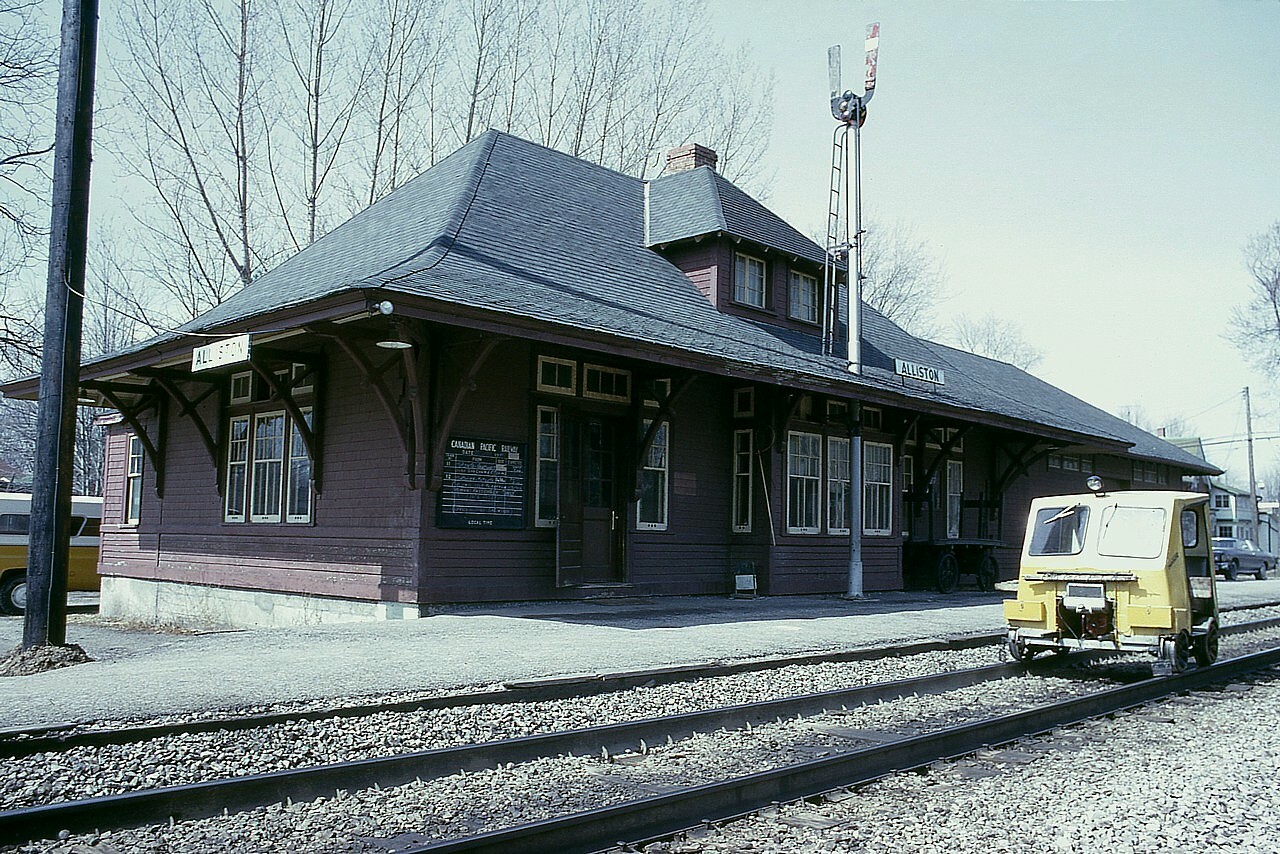 The old Alliston station as it looked in spring of 1976. Track car stopped out front. I am wondering if the station agent at this time was one Art Merrifield, a rather likeable and entertaining character in railroad photography circles in his day.
The station, built in 1908 was later purchased and moved to County Rd 10, north of Tottenham, and lived in as a fully restored residence by noted railroad photographer James A. Brown. Unfortunately, Jim passed away in 2020 and the property I understand is now up for sale.
