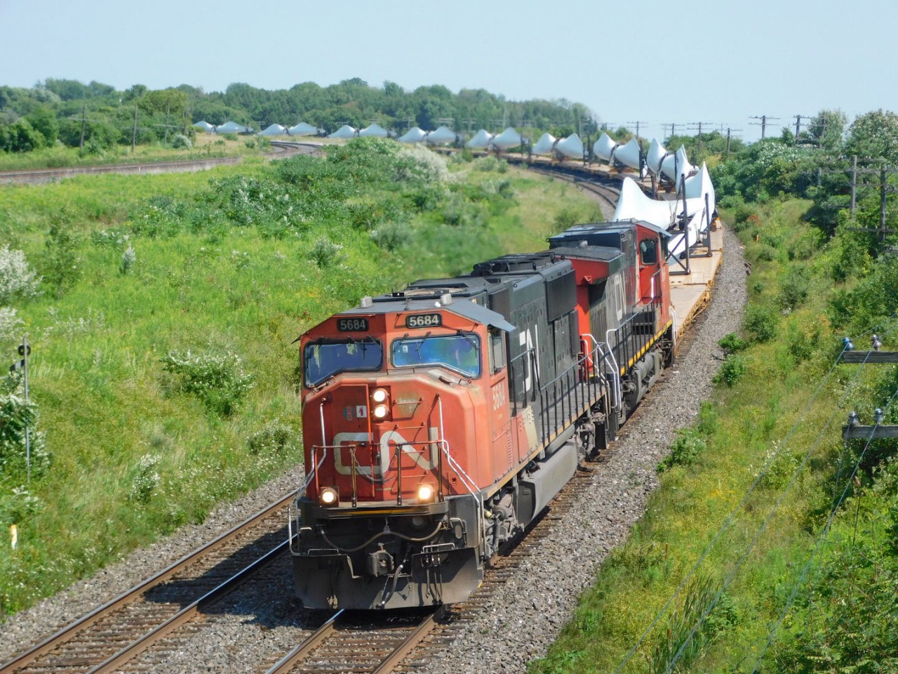 X319 rounds Lovekin curve hauling Windmill blades westbound. These are always awesome trains to see.
