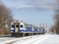 The mid-day run from Montreal to Candiac is approaching Montreal West station with two cab cars in its consist, with AMT 707 leading.