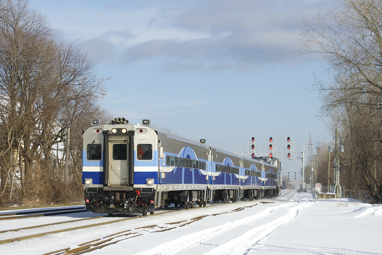 The mid-day run from Montreal to Candiac is approaching Montreal West station with two cab cars in its consist, with AMT 707 leading.