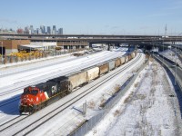 Clean CN 3199 leads an 188-car empty grain train towards a crew change at Turcot Ouest. Operating mid-train is CN 2680.