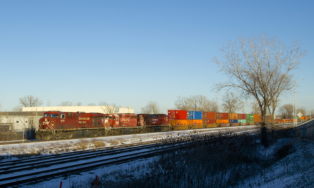 CP 143 has an SD40-2 in the dual flag paint scheme second as it passes through Dorval with 32 intermodal platforms followed by 72 autoracks. Power is CP 8711, CP 6012 & CP 8008.