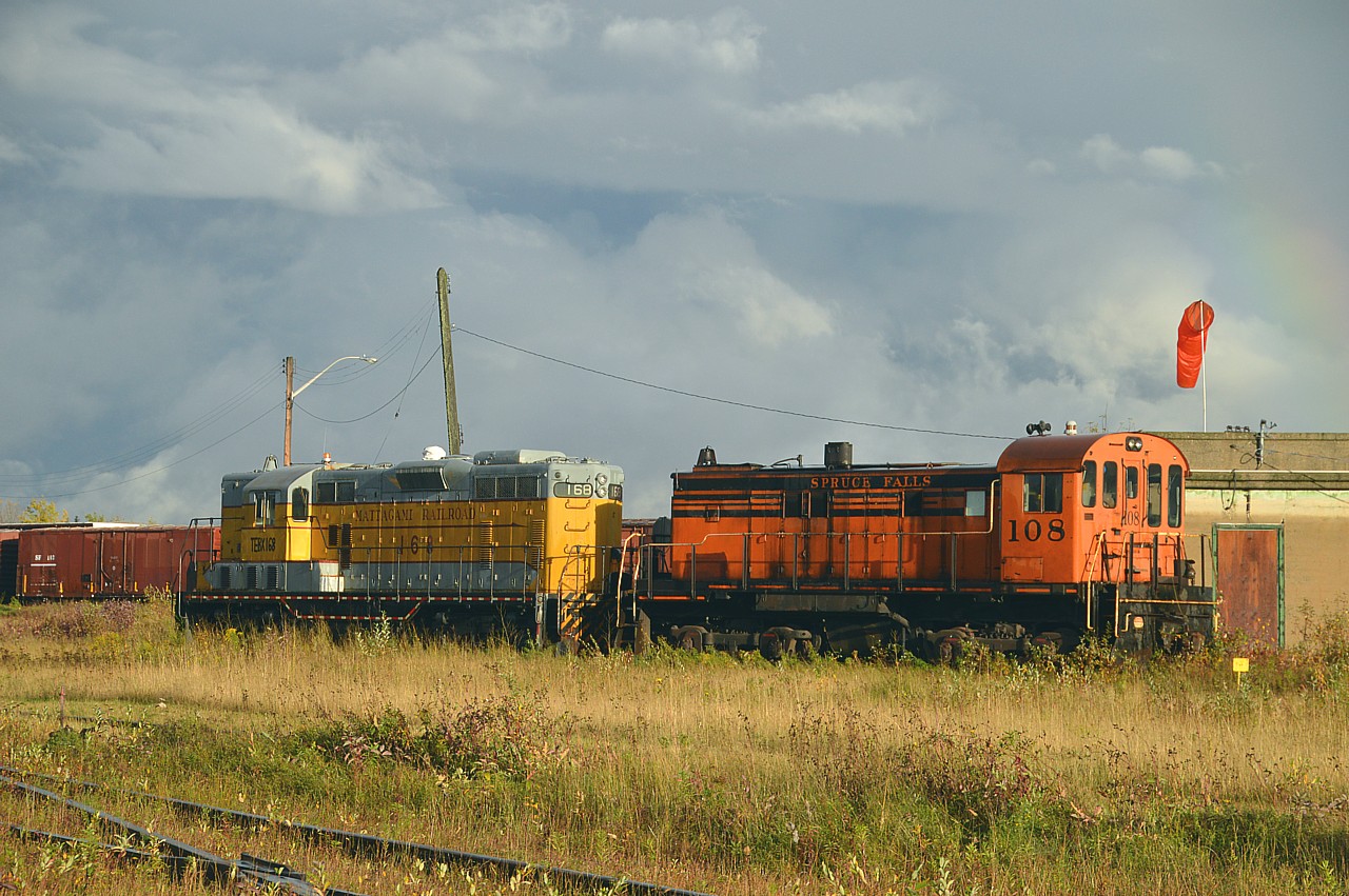 Due to the location of these locomotives and the rather dire weather forecast for the day; I waited out rainstorms, winds and generally lousy conditions hoping to get a photo of these two locomotives in sunlight.As luck would have it, the sun came out briefly in the very late afternoon and I was pleased with this shot. (Note a weak rainbow in the top right corner of this image).
Inside the fenced Rayonier (former Tembec) facility in Kap these two units look as if their days are done. The Spruce Falls S-13 #108 was acquired new by the company back in 1967. The former Mattagami RR #168 GP7 was acquired in 1998. (Before its Mattagami days, this unit toiled on Algoma Central as their 168)
While visiting there all rail activity at the plant was handled by a DESX 5176 (Diesel Electric Services)switcher. So the old units are probably expendable.
Rayonier is a producer of quality newsprint and other similar products.