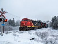 CN 2454 (GE C40-8M) with help from CN 8940 (EMD SD70M-2) and GMTX 2250 (EMD GP38-2) lead train 407 through Folly Mountain headed west towards Moncton New Brunswick’s Gordon yard 