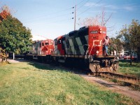 Heading south on the Government Spur, having just crossed Clarence Street.  The line here has no crossing lights, so it is under the Watchman's eye as they creak down the tracks.  With Cylindrical hoppers in tow, the GP9RM's are headed for the Maple Leaf Mill and Port Colborne Grain Terminal (ex - Ports Canada -  Government Elevator).  The tracks here exist from at least 1907, and when the Government Elevator opened in 1908 the facility was connected by a Causeway through Lake Erie that supported the rail line.   