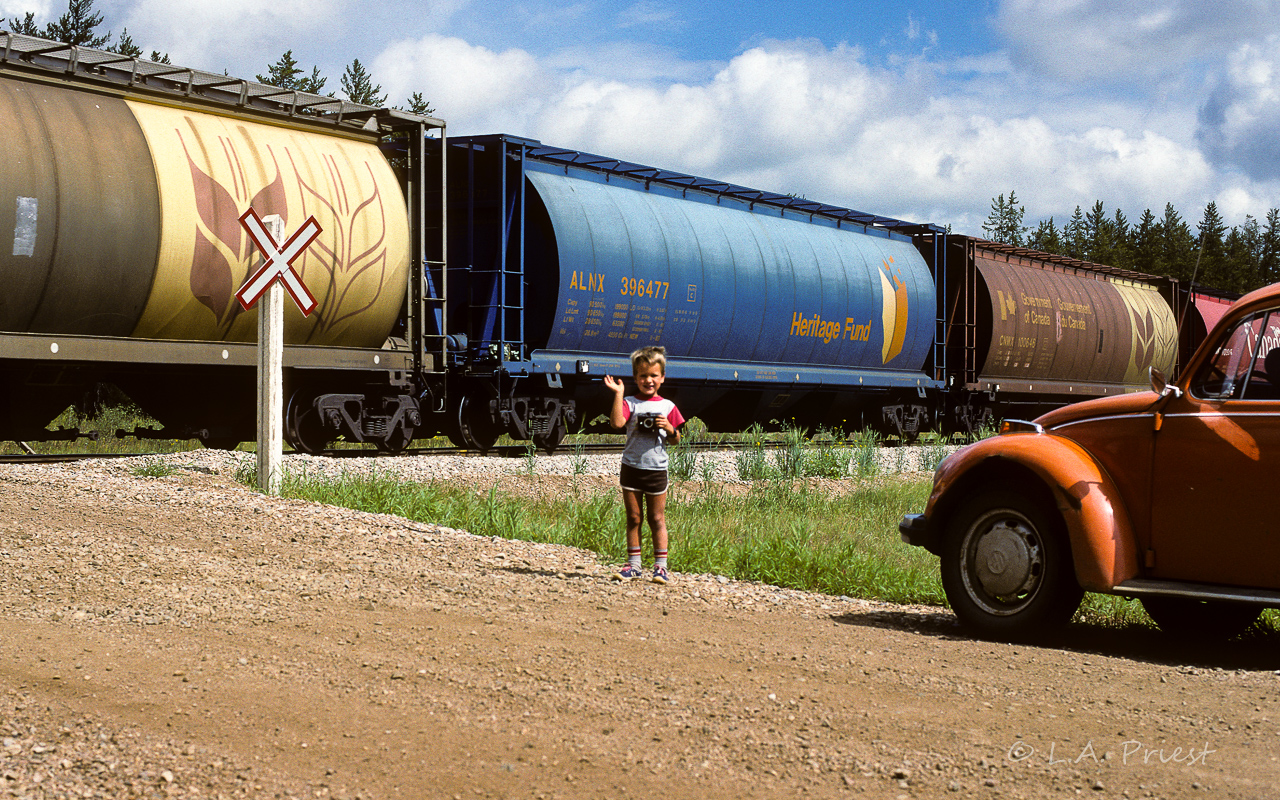 A tribute to my co-pilot who rode with me for a few years (or at least until he was old enough for grade 1). He likes trains as much as his Dad. Holding a squirt gun joke camera, converted into easier working toy camera. Always kept in the car ready for action (that's the chase VW). Thanks for making those waits on the side of the road more enjoyable by throwing rocks, flying kites, catching snakes, etc. :-)