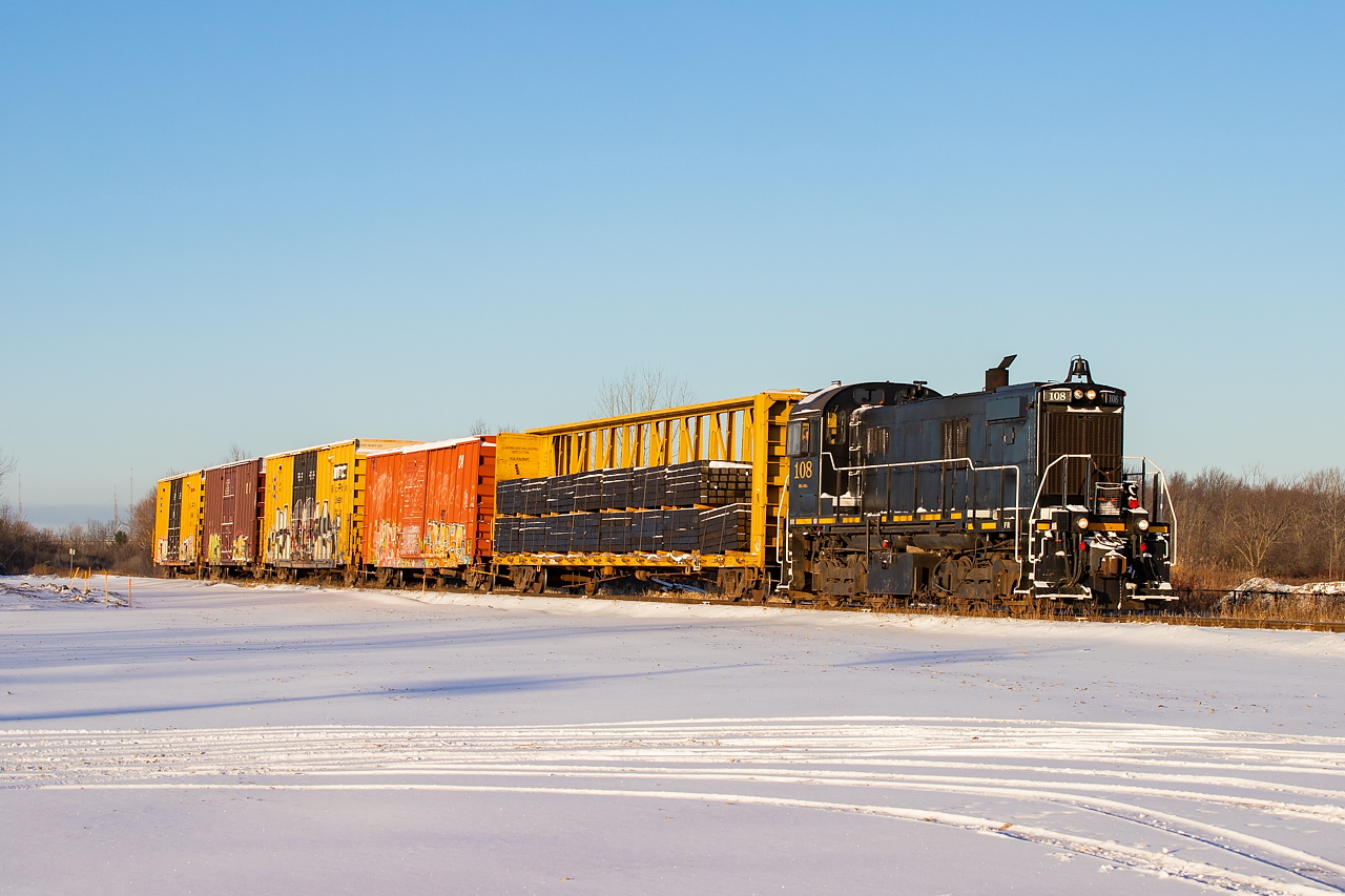 Trillium (or is it GIO now - honestly I am not even sure) 108 rolls by the future home of their two-bay engine house (that will fit four units I am told). They've been parking the power at Feeder since the Spring, and I was told the build of this engine facility was to have been completed by now, so I can't really speak to the timing of when it will even start at this point. Before this they'd parked their power by Atlas Steel in Welland, where the deadline still makes its home. The ties, coming to Trillium off of CP, will be dropped near SLM in Welland and unloaded by the section crew, and the boxcars will continue on to St. Catharines.