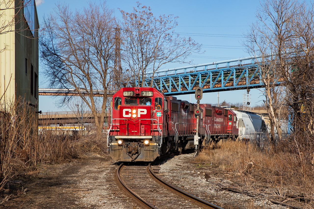 CP TH11 crosses the diamond at Irondale in Hamilton's north end, with a drag of empties from Bell & MacKenzie.