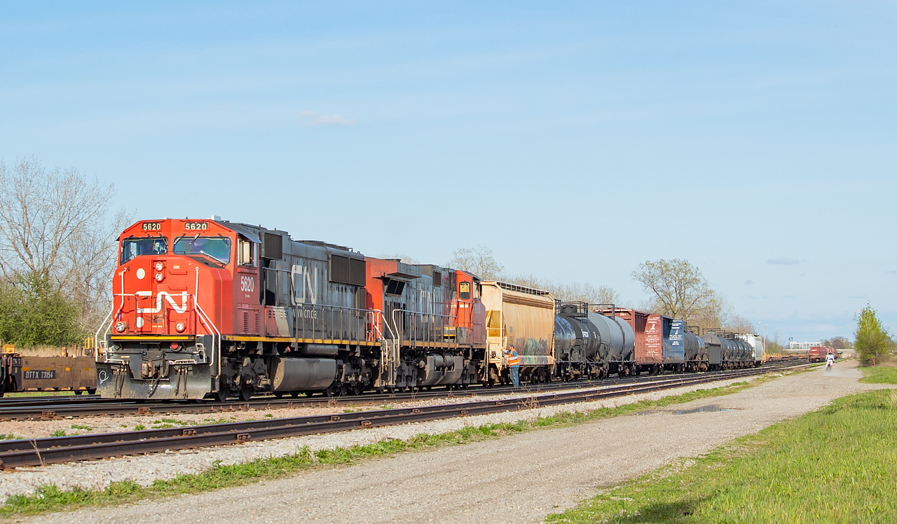 CN L561 has just returned from the BPRR over in Buffalo, and after leaving their cars from the BPRR on the main at Duff (shown here), are tying onto the setoff just left by NS C93. The dirt biker at right is a fairly common sight while railfanning in Niagara - with no shortage of quad/dirt bike trails in the vicinity of the tracks throughout the Region.