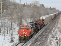 A friendly wave from the engineer as CN train 384 switches from the north to south track at Hardy in Brantford's west end. A nice layer of light snow has covered to trees here as the sun briefly peeks out before more blowing snow fills the skies once more. 