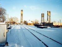 End of the line for the Dunnville Subdivision, a few days earlier crews were out removing traditional lettered Crossbucks, Wig Wags, Crossing Lights and other hardware on either end of the tracks east and west of Port Colborne.  Approx. 125 years of through freight traffic ended in 1977 and in the intervening years the line was rarely used except for the Port Colborne section.  The crews filled Two (2) gons full of the stuff which are seen parked at the Downtown Spur opposite the 1926 built CNR station.  The Downtown Spur was removed shortly after this photo was taken and the location was converted to a Parking Lot.  The Spur was on the previous site of a large CNR Freight Shed, and in latter years was used to offload lumber and farm implement machinery.  The PC CNR Road-Switcher also overnight parked there, or at the south end of the Furnace Yard on the East Side.  In the photo the CNR station still has the CN EXPRESS FREIGHT  and the TH&B FREIGHT OFFICE signs on end wall (right side).  The station was boarded up 2 years earlier when the Elm Street Spur to ROBIN HOOD was removed since service from Feeder was extended down the old NS&T right of way to CASCO (now JUNGBUNZLAUER) and then connected to ROBIN HOOD.  Removal of Bridge 20 began almost exactly 24 years ago.